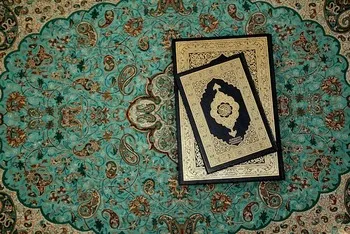 quran on green carpet